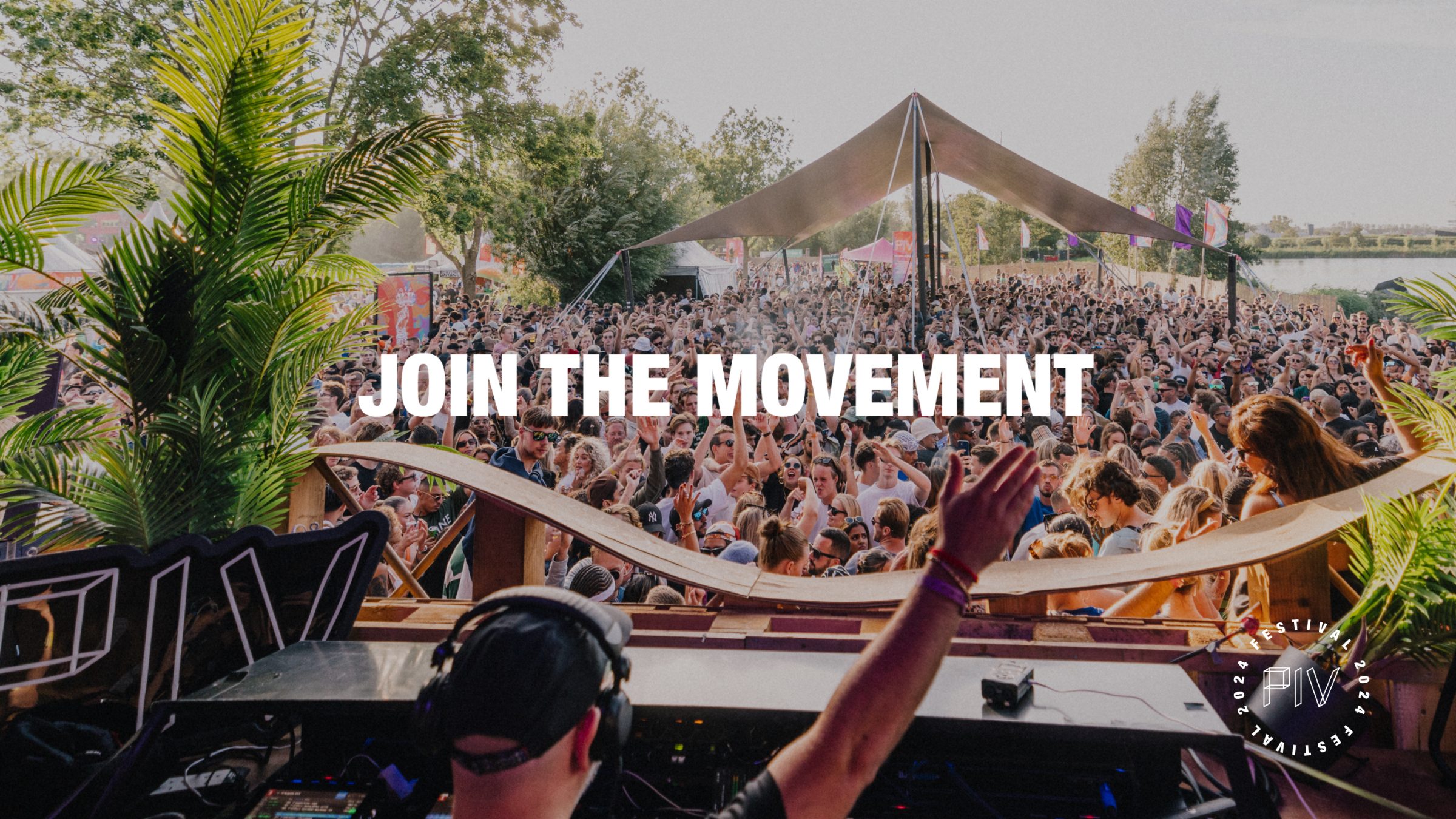 the festival crowd seen from the dj booth, under the line join the movement